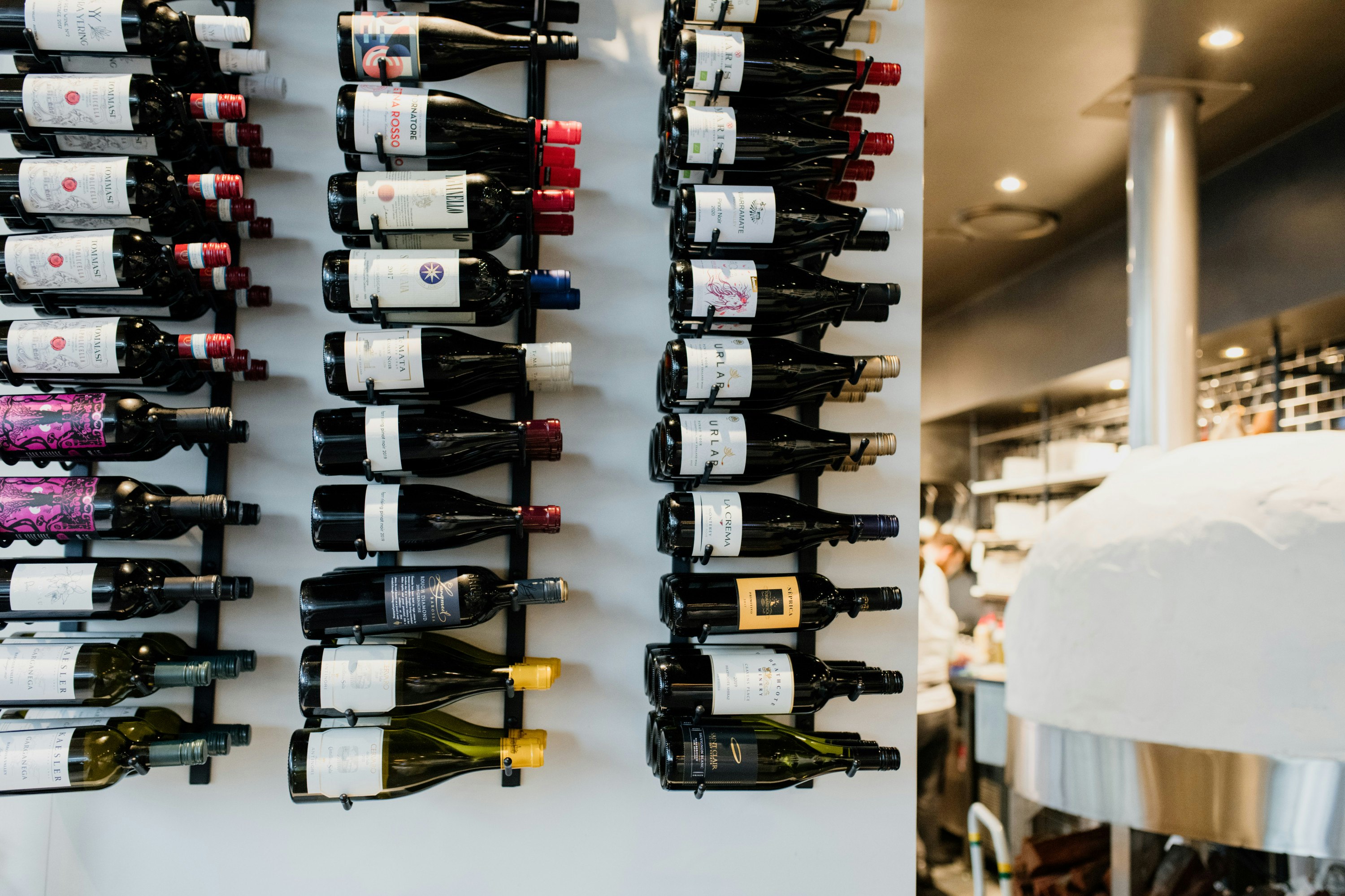 a wall stacked with bottles of wine